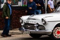 Havana, Cuba Ã¢â¬â 2019. Old guys admiring vintage American classic cars in Havana
